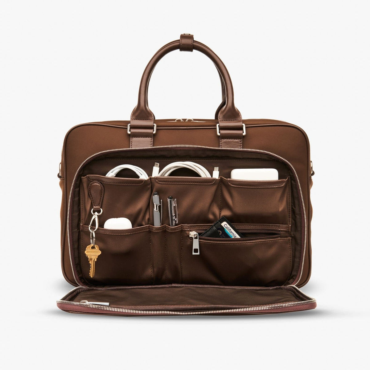 The brown Alto's front organiser open, holding cables, pens and keys