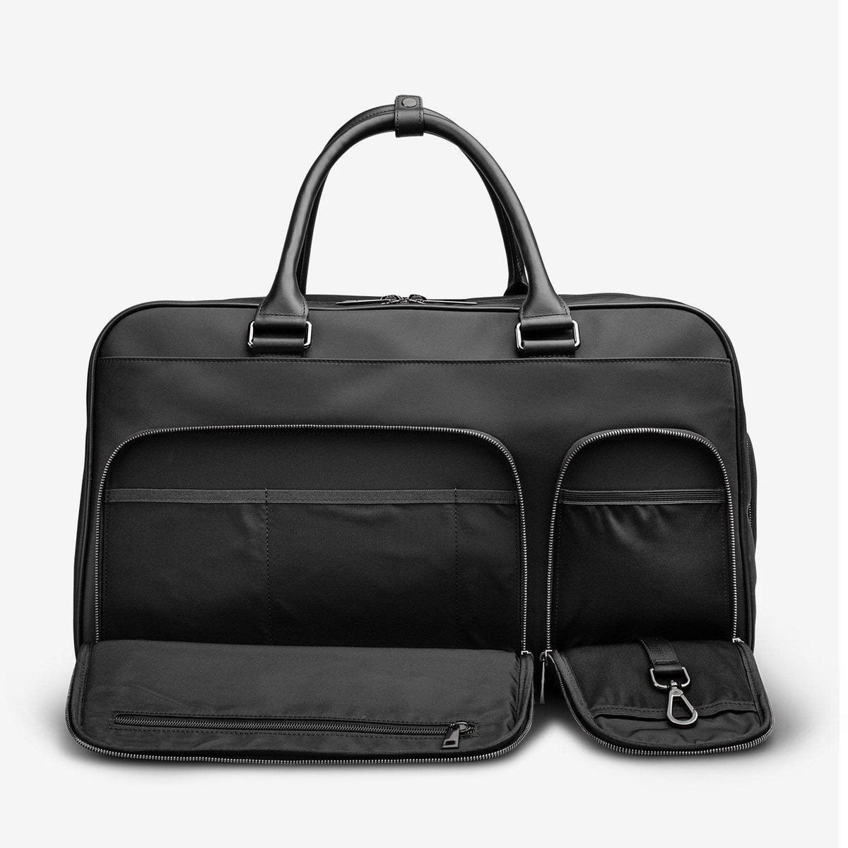 The black Kennedy Weekender with its separate shoe compartment unzipped at the base