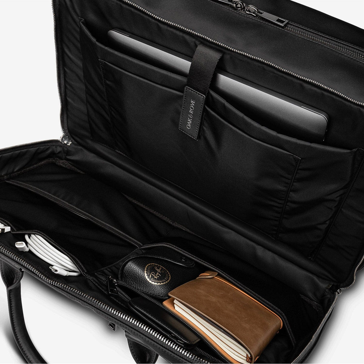 The Kennedy's tech compartment with a laptop, chargers and cables